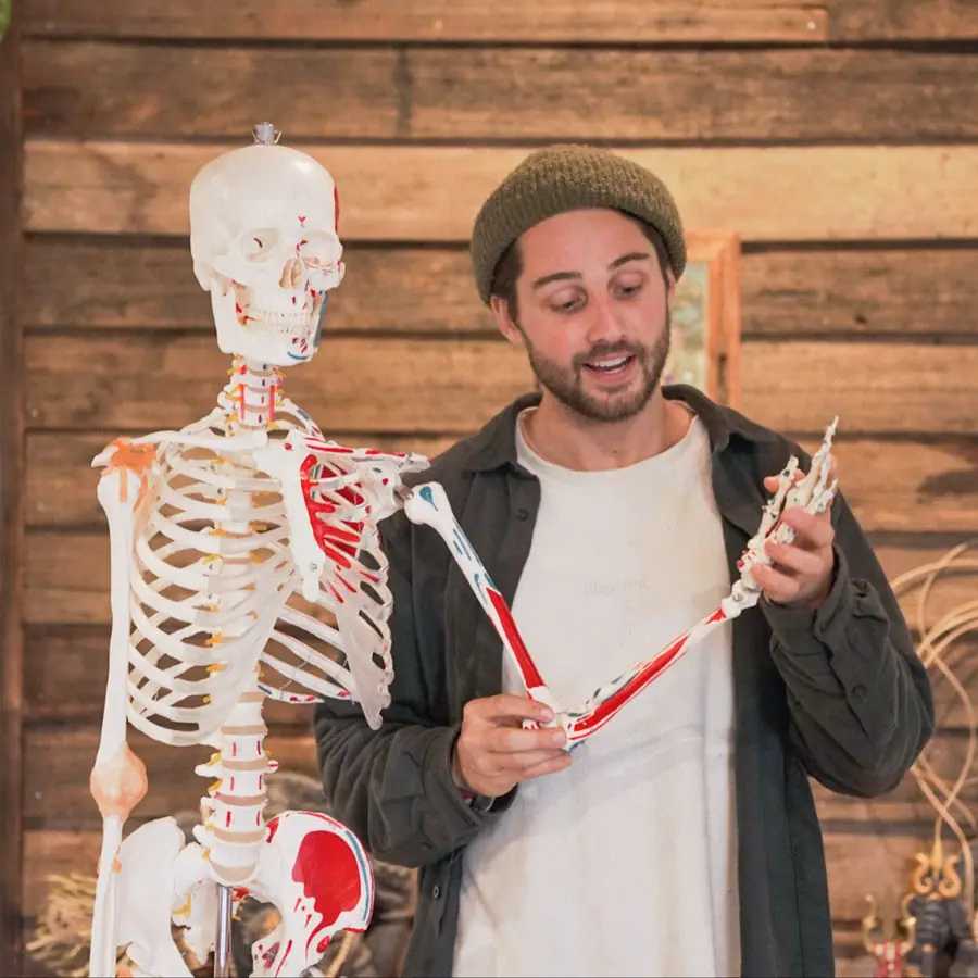 Aaron teaching anatomy with a skeleton model
