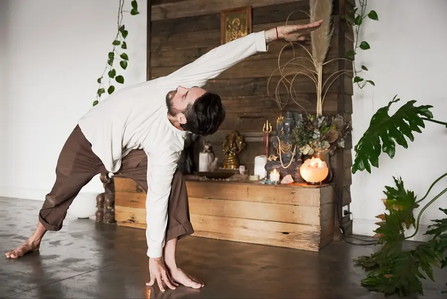 Aaron in a side bend at the studio altar