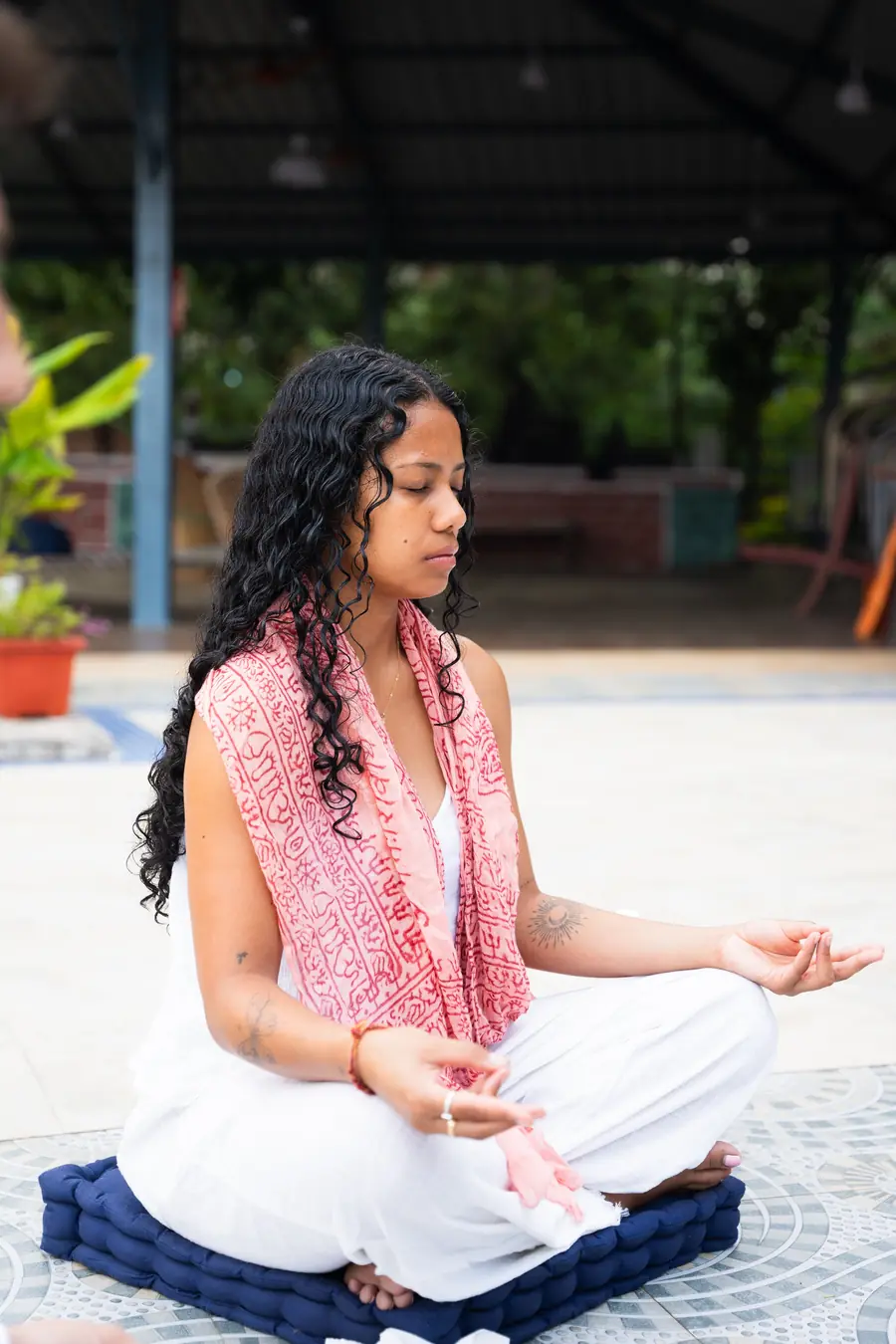 A student meditating on a terrace in Rishikesh, India