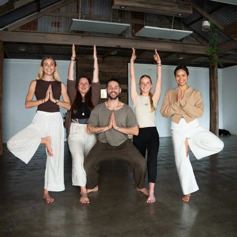 The Sadhana Sangha teachers in tree pose in the studio