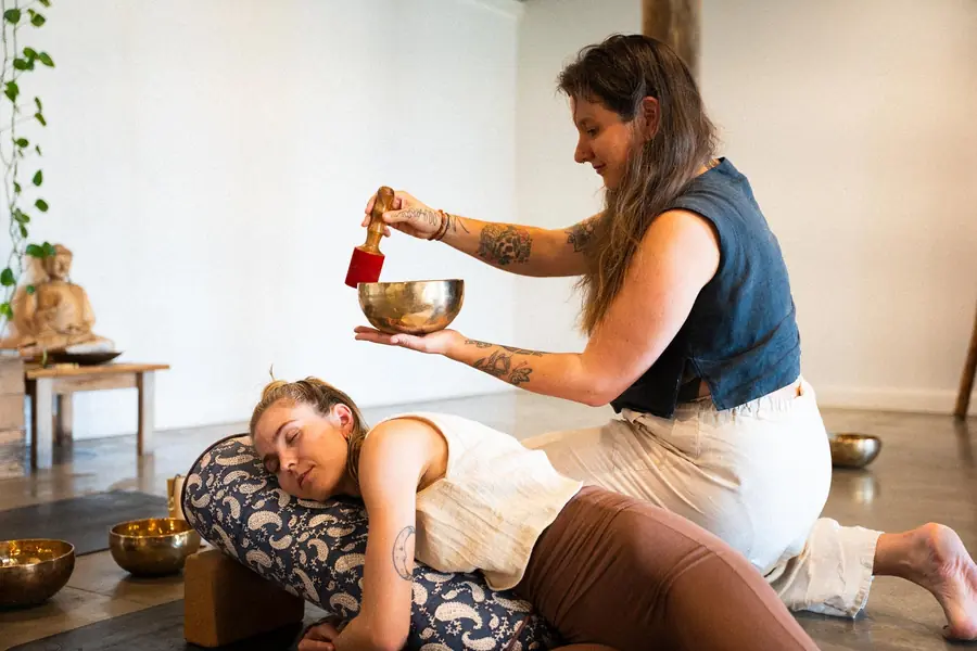 A singing bowl played beside a resting student