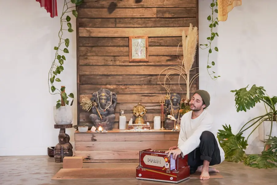 A teacher playing the harmonium