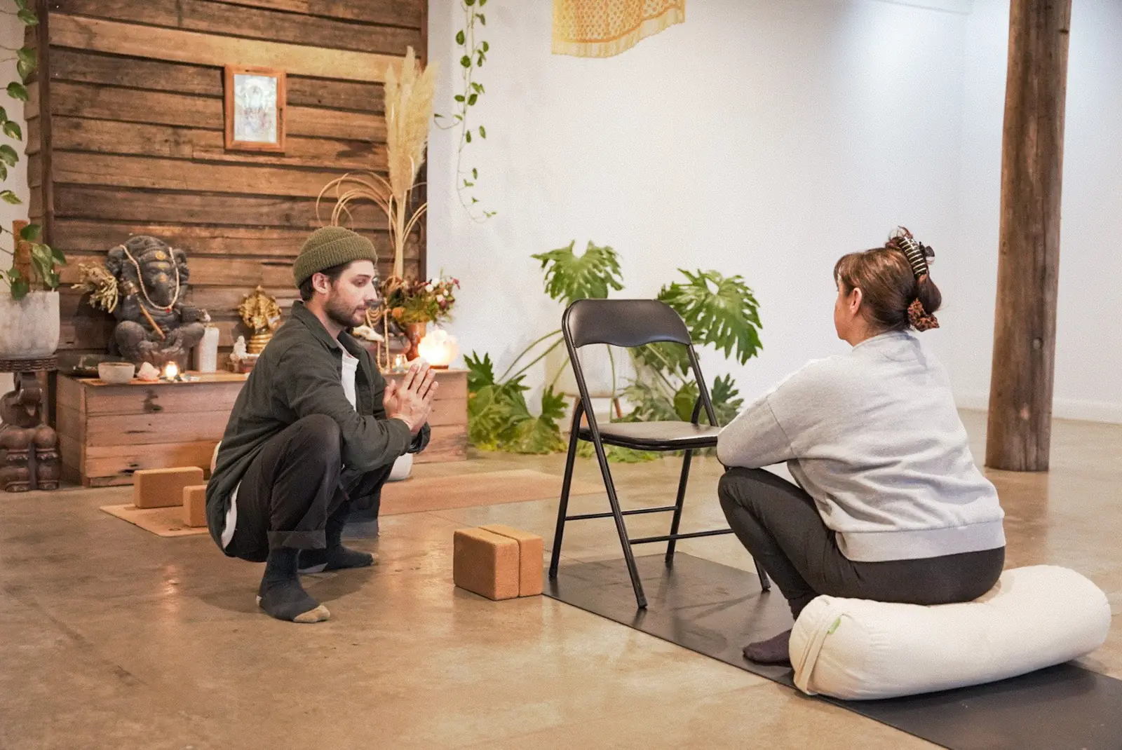 Aaron guiding a client through a supported chair practice in the Berwick studio